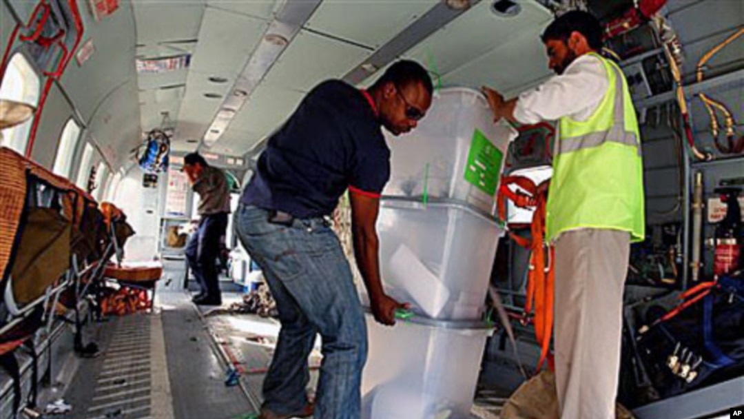 UN workers unload disputed ballot boxes from a FILE - UN helicopter at Kabul International Airport before being transferred to the Independent Elections Commission (IEC) warehouse for auditing, in Kabul, Afghanistan.