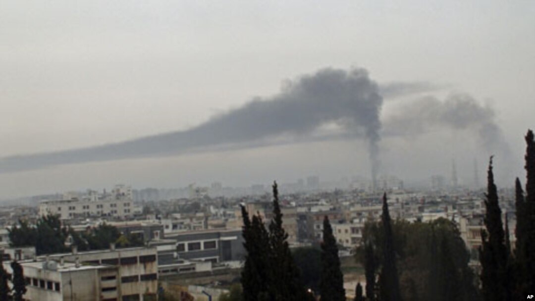 Smoke billows in Homs after the city is shelled by what activists say were Syrian troops, February 17, 2012.