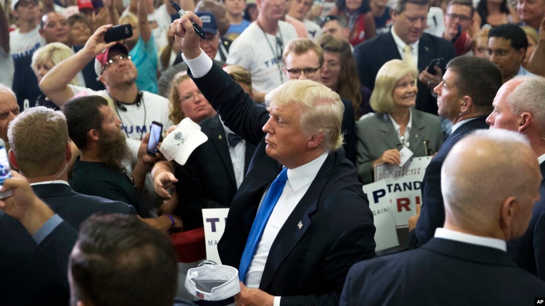 Republican presidential candidate Donald Trump greets the crowd and signs autographs during a campaign rally at the Sharonville Convention Center, July 6, 2016, in Cincinnati, Ohio. 