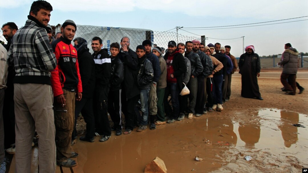 Newly arrived Syrian refugees wait their turn to receive mattresses, blankets and other supplies, and to be assigned to tents, at the Zaatari Syrian refugees camp in Mafraq, near the Syrian border with Jordan, Jan. 28, 2013.