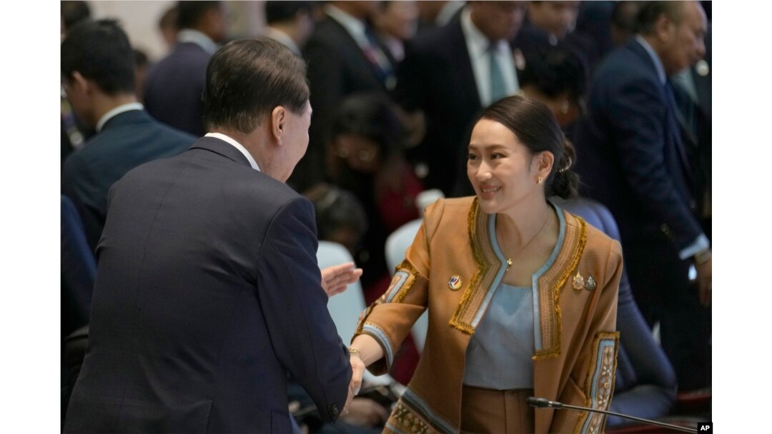 South Korean President Yoon, left, shakes hands with Thailand's Prime Minister Paetongtarn Shinawatra at the 25th ASEAN - South Korea Summit to commemorate the 35th Anniversary of Dialogue Relation in Vientiane, Laos, Oct. 10, 2024.