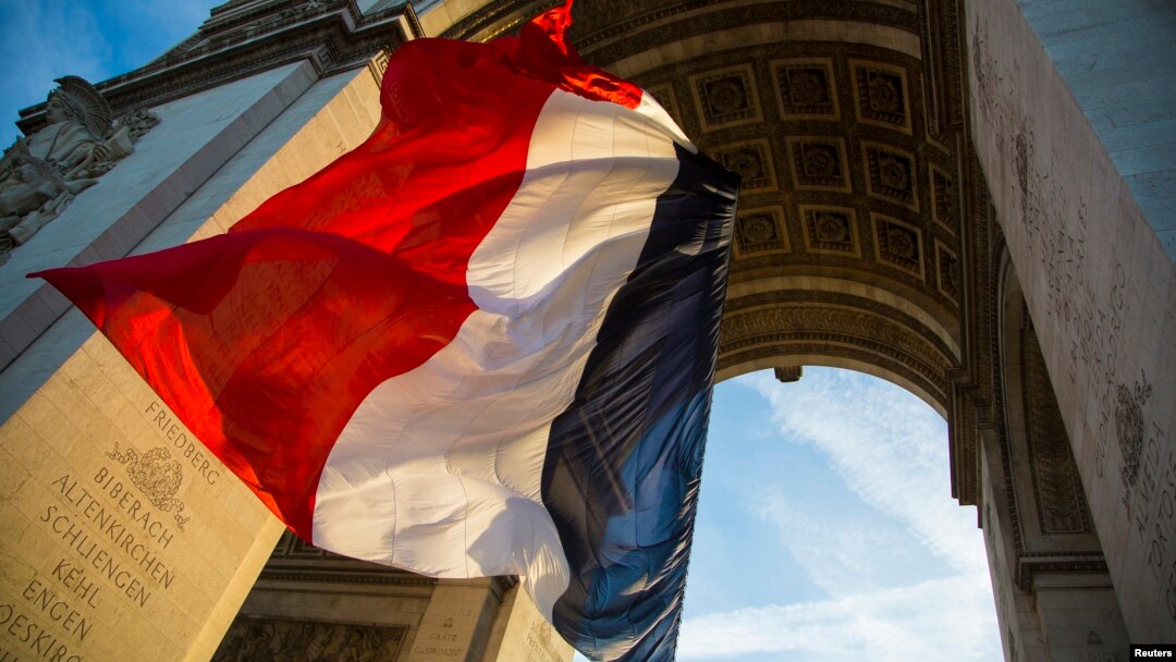 FILE - The French flag flies under the Arc de Triomphe during a ceremony to commemorate the end of the World War One in Paris, Nov. 11, 2013. 