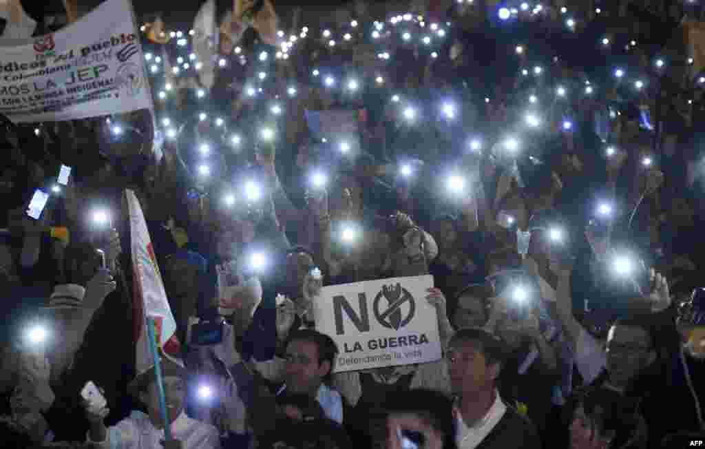 People protest against reform proposed by the government for the Special Jurisdiction for Peace (JEP) with a sign reading "No to war" in Bogota, Colombia, on March 18, 2019.