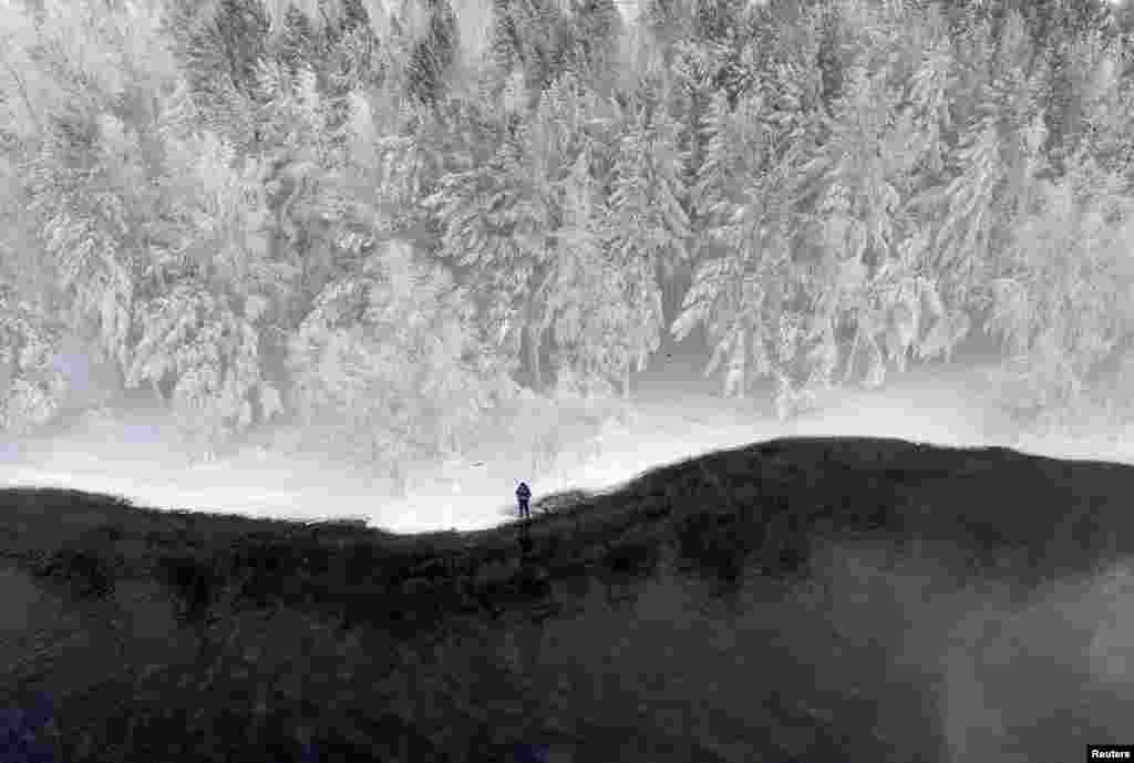A man fishes on a bank of the Yenisei River covered with snow and hoarfrost outside the Siberian city of Krasnoyarsk, Russia.