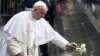 Pope Francis places a white rose at the South Pool of the 9/11 Memorial in downtown Manhattan, Sept. 25, 2015, in New York.