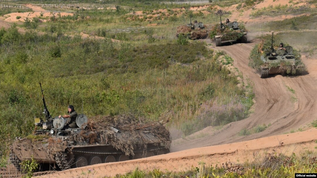 FILE - Soldiers conduct military exercises near Sankt Petersburg, Russia, Aug. 17, 2018. 