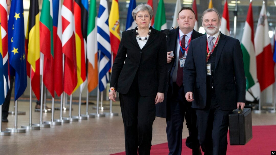 British Prime Minister Theresa May, left, arrives for an EU summit at the Europa building in Brussels, March 23, 2018.