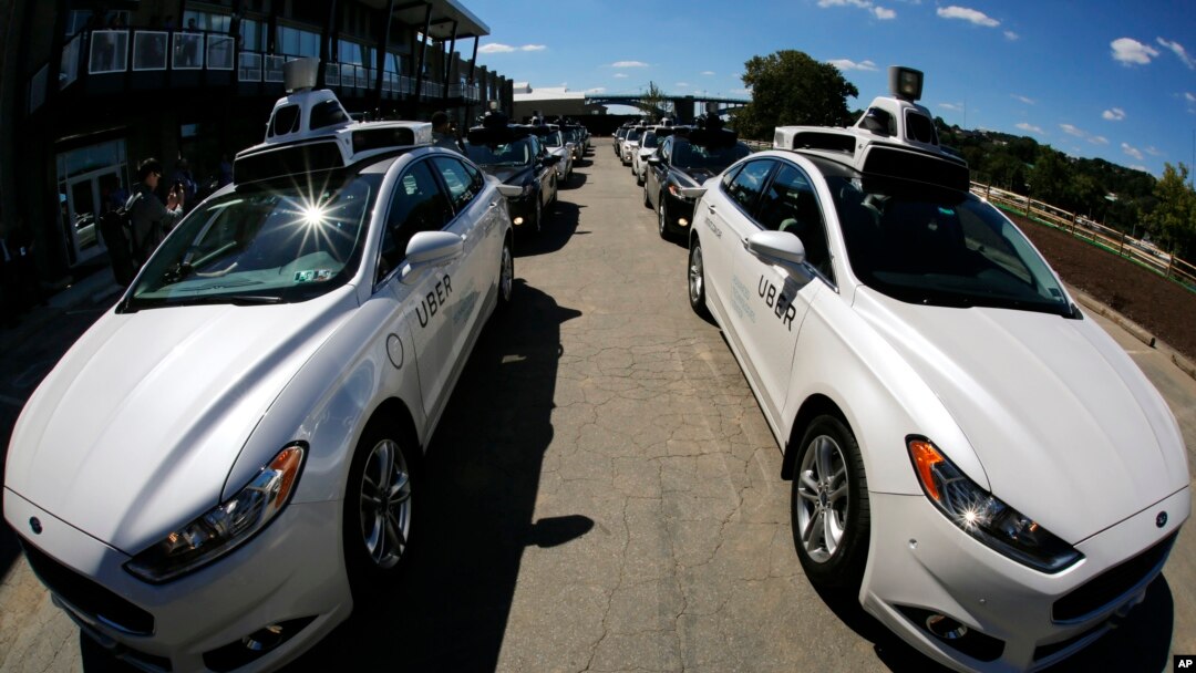 In this Monday, Sept. 12, 2016, photo, a group of self-driving Uber vehicles position themselves to take journalists on rides during a media preview at Uber's Advanced Technologies Center in Pittsburgh. (AP Photo/Gene J. Puskar, File)