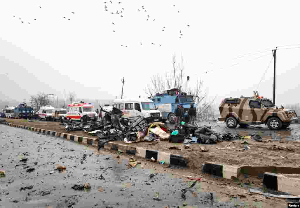 Indian soldiers examine the debris after an explosion in Lethpora in south Kashmir's Pulwama district.
