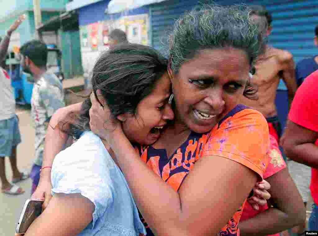 People who live near the church that was attacked on Easter Sunday, leave their houses as the military tries to defuse a suspected van before it exploded in Colombo, Sri Lanka.
