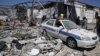 Debris covers the ground and an emergency vehicle after an airstrike at a detention center in Tajoura, east of Tripoli in Libya, Wednesday, July 3, 2019. 