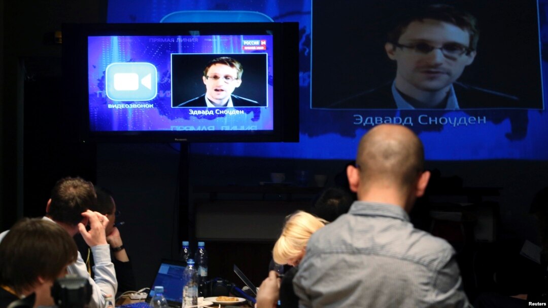 Journalists listen to a speech and a question posed by former U.S. spy agency NSA contractor Edward Snowden, at a media center during Russian President Vladimir Putin's live broadcast nationwide phone-in, in Moscow, Russia, April 17, 2014.