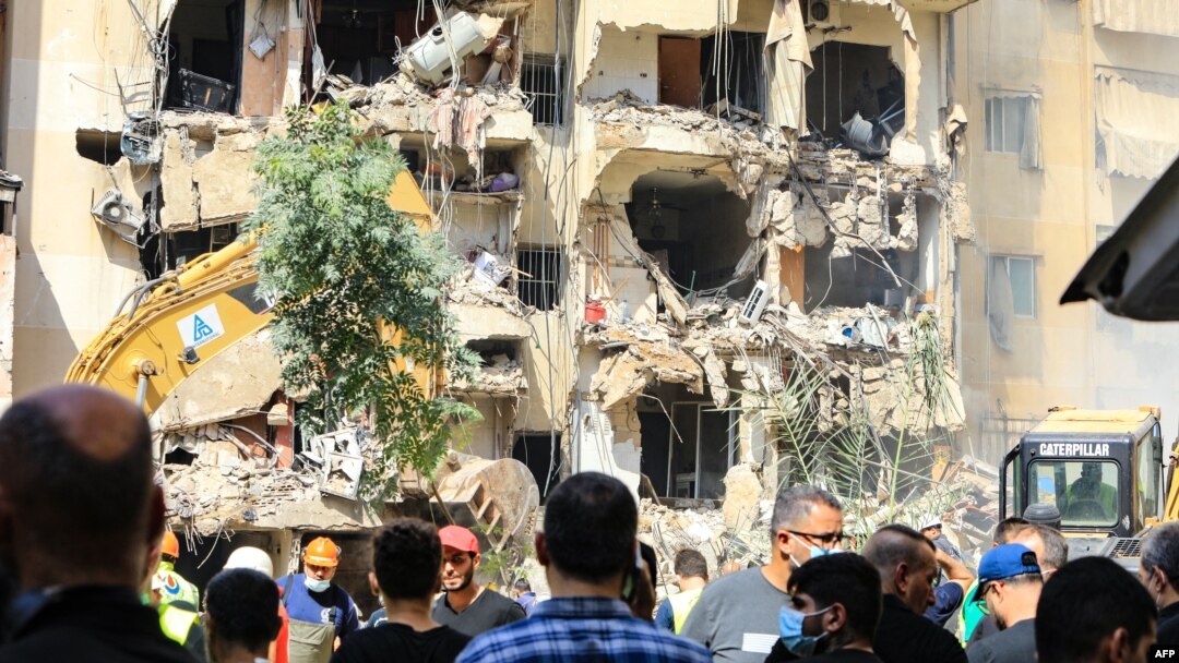 Un grupo de personas observan los destrozos causados por un ataque israelí en un suburbio del sur de Beirut, el 21 de septiembre de 2024.