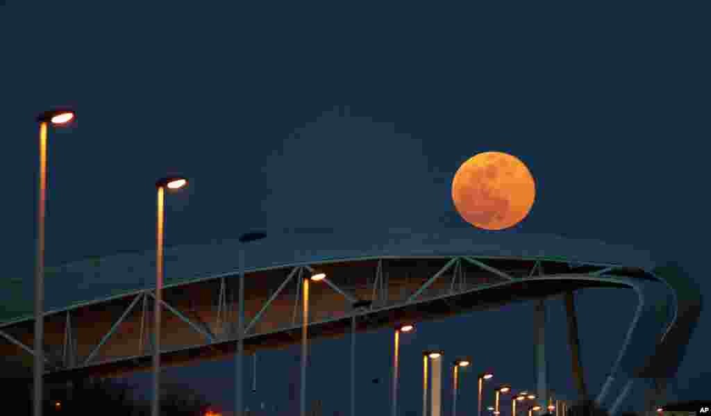 A supermoon rises over Tagus river in downtown Lisbon, Portugal, Feb. 19, 2019.