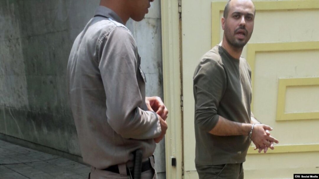 In this photo shared on social media, Iranian journalist Masoud Kazemi is seen handcuffed after being arrested in Tehran, May 22, 2019, for alleged security offenses.