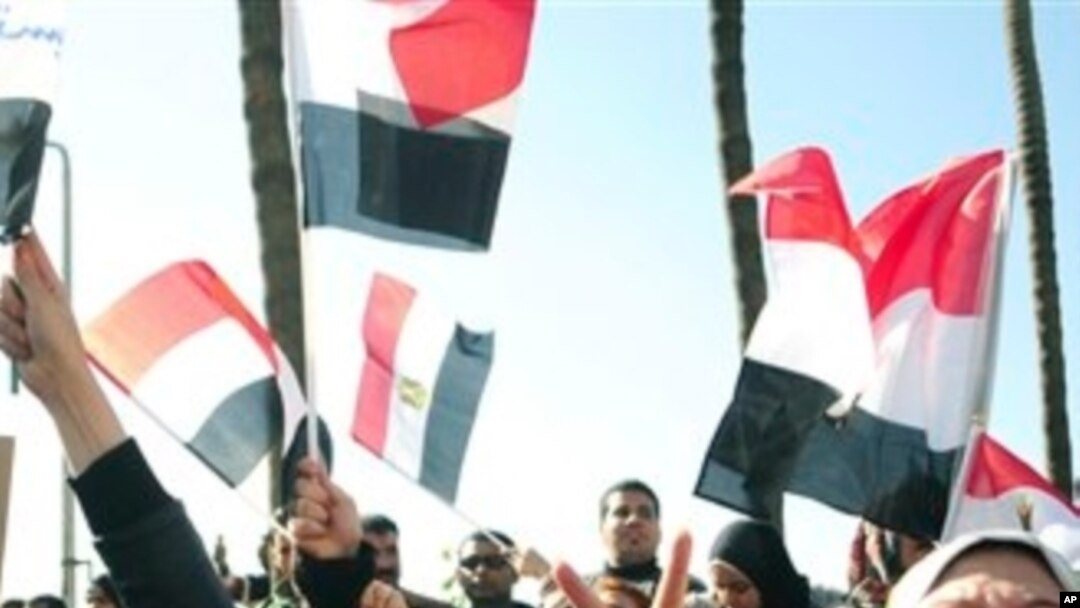 Egyptian anti-Mubarak protesters shout slogans as they march in Alexandria, Egypt, Feb 8, 2011