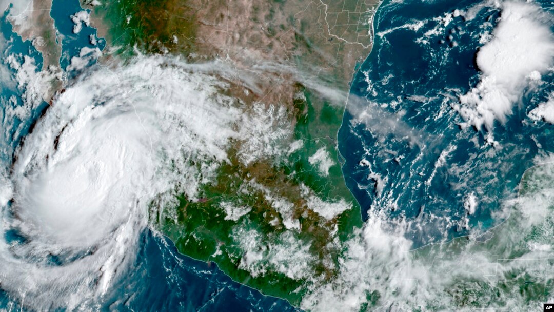 This satellite image provided by the National Oceanic and Atmospheric Administration shows Hurricane Olaf on the Pacific coast of Mexico approaching the Los Cabos resort region, early on Sept. 9, 2021.