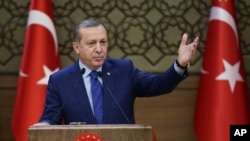 FILE - Turkish President Recep Tayyip Erdogan addresses a meeting of local administrators at his palace in Ankara, March 16, 2016. 