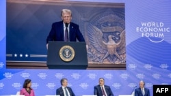 TotalEnergies chairman and CEO Patrick Pouyanne (2ndR) asks a question to US President Donald Trump (on screen) during his address by video conference at the World Economic Forum (WEF) annual meeting in Davos on January 23, 2025.