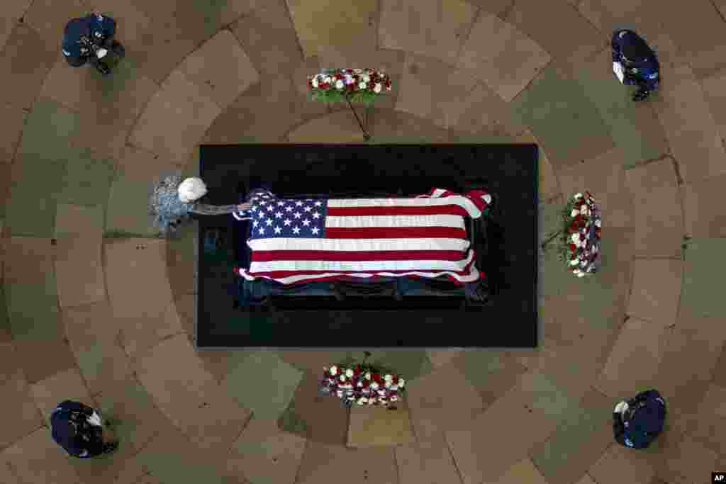 Landra Reid touches the casket of her husband, former Sen. Harry Reid, D-Nev., as he lies in state in the Rotunda of the U.S. Capitol in Washington.
