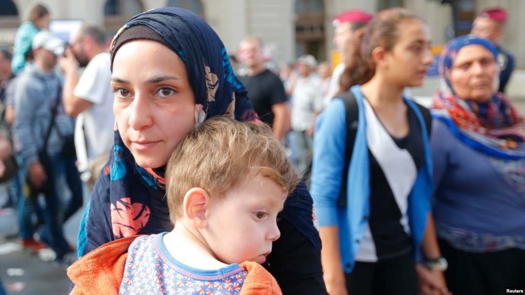 Migrants leave the main Eastern Railway station in Budapest, Hungary, Sept. 1, 2015.