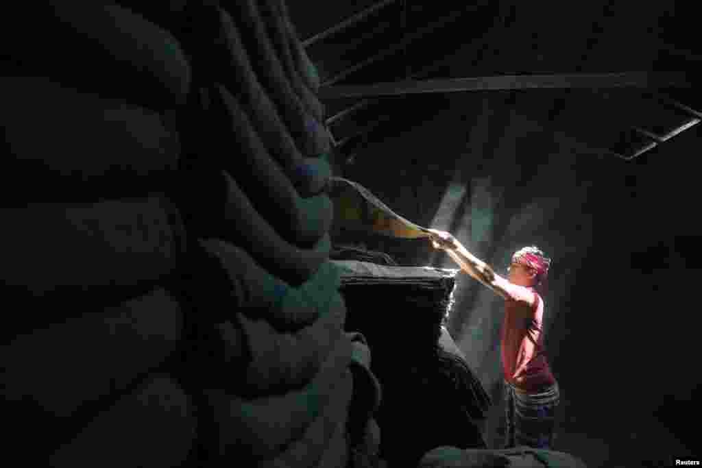 A worker stacks jute sacks in a shop in Munshiganj, Bangladesh.