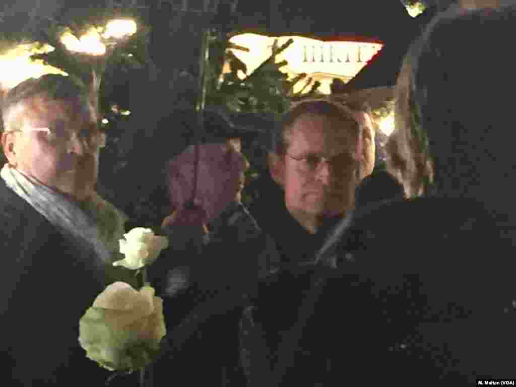 Berlin Mayor Michael Muller, right, assured Berliners that while "there cannot be absolute security" at the public market, the city has taken all measures possible to guard against any repeat of last year's attack. Muller was one of a number of officials who placed a white rose at a memorial to the victims of the attack.