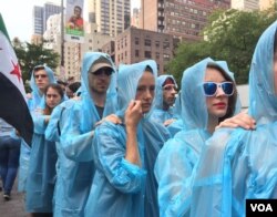 An artistic protest performance called "Backward march: The World Backs Down to Iranian Terror." These protesters marched 3 kilometers backwards to the United Nations as Iranian President Hassan Rouhani was speaking to the UN General Assembly. They wer