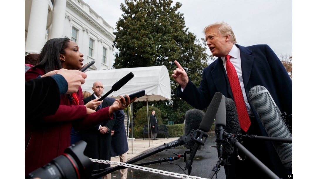 CNN journalist Abby Phillip asks President Donald Trump a question as he speaks with reporters before departing for France on the South Lawn of the White House, Nov. 9, 2018.