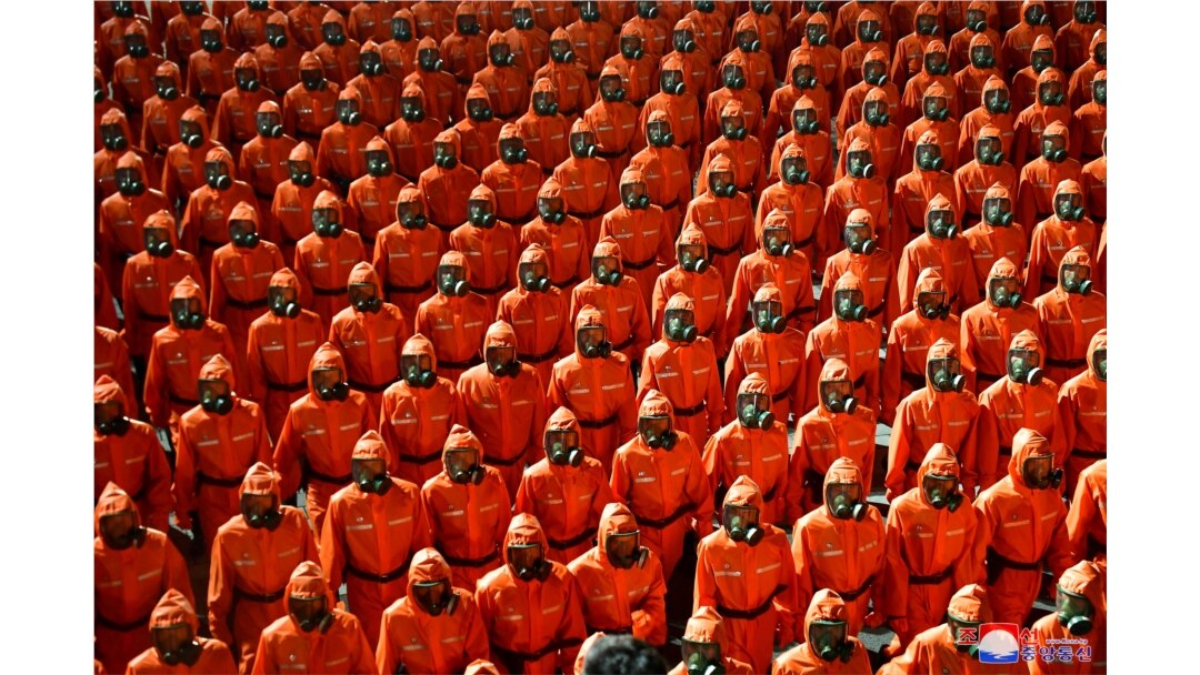 Personnel in orange hazmat suits march during a paramilitary parade held to mark the 73rd founding anniversary of the republic at Kim Il Sung square in Pyongyang in this undated image supplied by North Korea's Korean Central News Agency on September 9, 20
