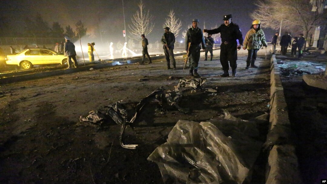 FILE - Afghan security forces inspect the site of a suicide attack near the Russian embassy in Kabul, Afghanistan. Conditions in Afghanistan are getting worse, 15 years into a war that few Americans talk about any more, Jan. 20, 2016.