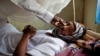 FILE - A patient with hepatitis is treated at a hospital in El Sereif village, North Darfur, Sudan.