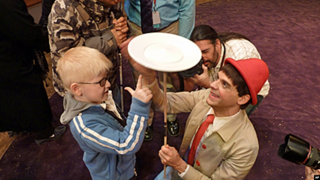 A visually impaired boy learns the joy of spinning at the Big Apple Circus of the Senses.