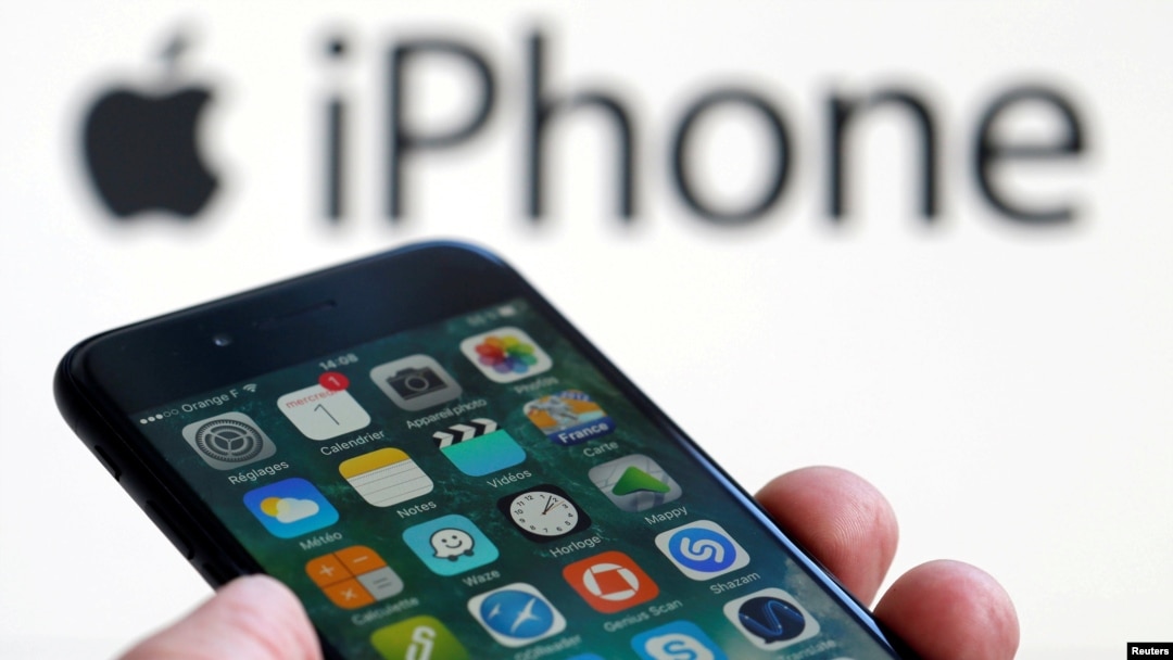 FILE - An Apple iPhone 7 and the company logo are seen in this picture taken, Feb. 1, 2017.