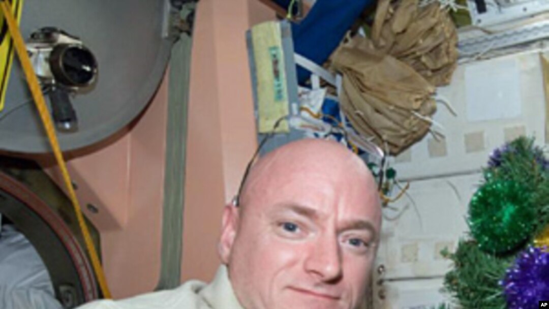 NASA astronaut Scott Kelly, Expedition 26 commander, poses for a holiday photo near Christmas decorations in the Unity node of the International Space Station