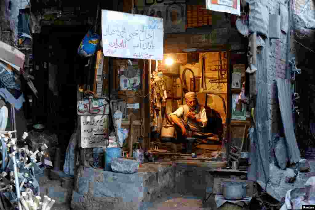 A blacksmith sits in his shop at the Souq al-Melh market in the old quarter of Sana'a, Yemen, Jan. 9, 2019.