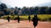FILE - Myanmar army soldiers carrying weapons patrol on a road as part of operations against ethnic rebels, in Kokang, northeastern Shan State, more than 800 kilometers (500 miles) northeast of Yangon, Myanmar.