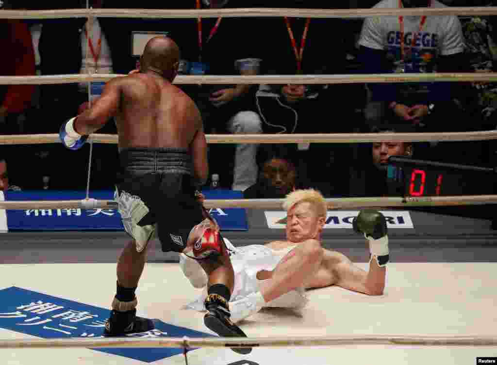 Floyd Mayweather knocks down Tenshin Nasukawa of Japan in the first round of their three-round exhibition match on New Year's Eve, at Saitama Super Arena in Saitama, north of Tokyo, Japan.
