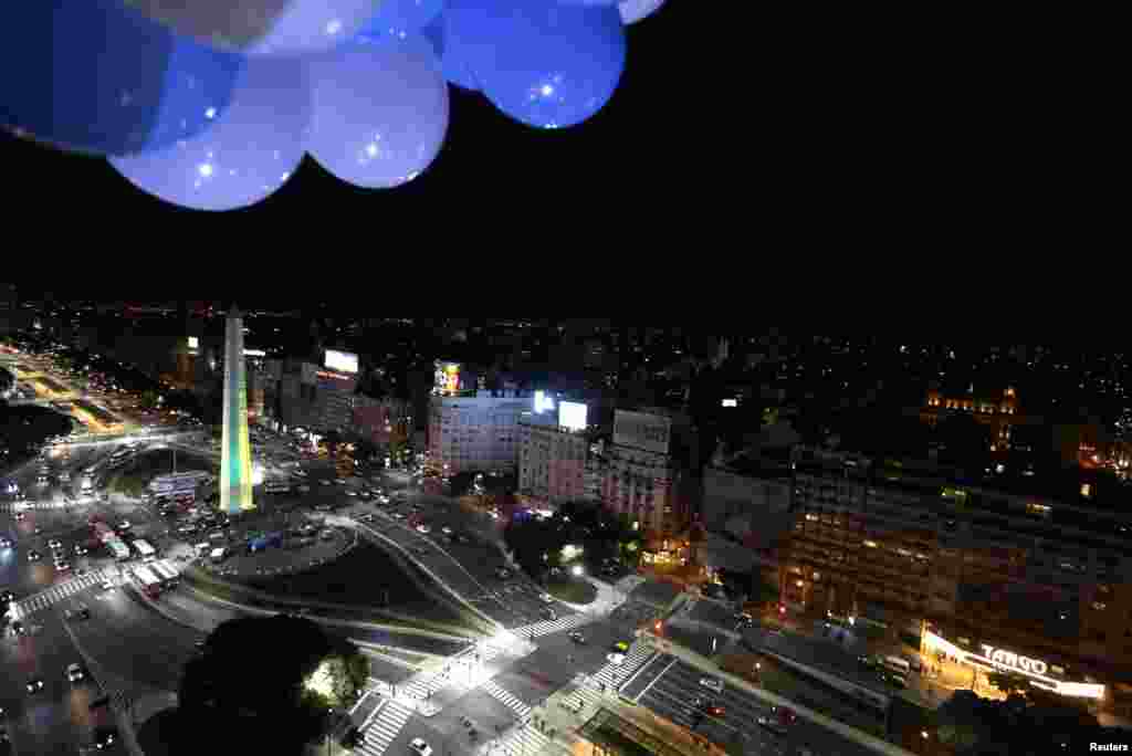 The Obelisk is lit up in the Brazilian team colors of yellow and green in Buenos Aires. On the eve of the opening of the World Cup in Rio de Janeiro, Christ the Redeemer will be lit up in the blue and white colors of the Argentine national team to show sportsmanship between the two nations, June 10, 2014.