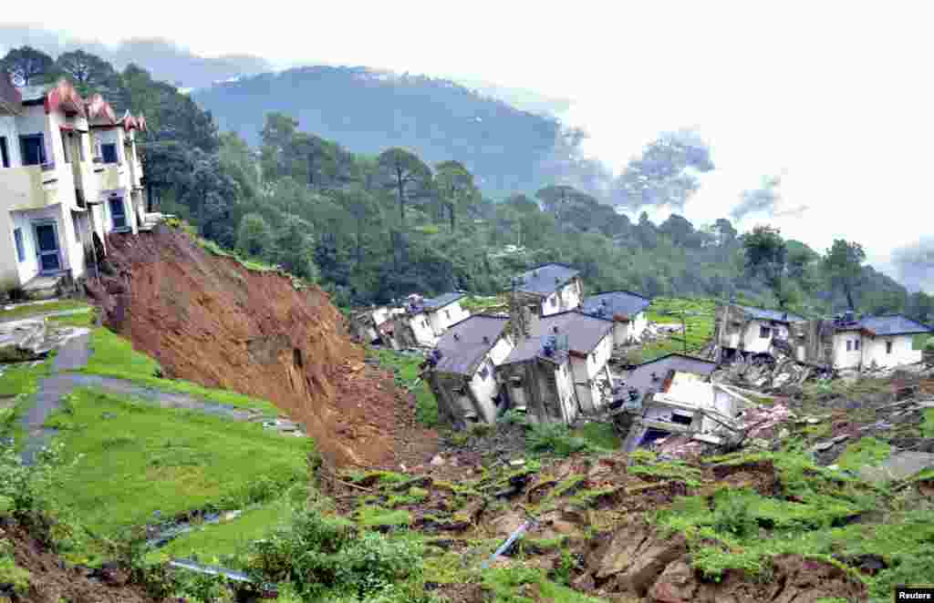 Damaged residential houses of the Indian army are seen after a landslide caused by heavy rains in Tihra Lines near the northern hill town of Dharamsala.