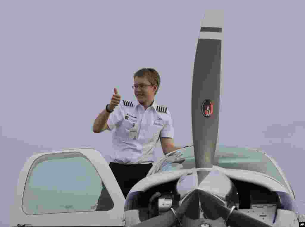 Young American pilot Matt Guthmiller, from Aberdeen, South Dakota, flashes a thumbs-up sign from his single-engine Beechcraft Bonanza A36 plane after landing at the Manila International Airport at suburban Pasay city, Philippilippines. Guthmiller, 17, is attempting to be the youngest pilot to fly solo around the world. He has eight more legs to complete his feat with Darwin, Australia, as his next stop.