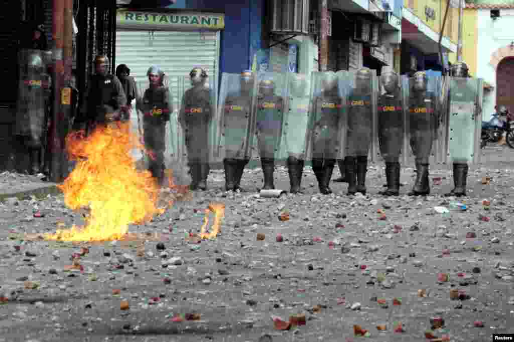 Security forces look on while clashing with opposition supporters participating in a rally against Venezuelan President Nicolas Maduro's government and to commemorate the 61st anniversary of the end of the dictatorship of Marcos Perez Jimenez in Tachira, Jan. 23, 2019.