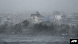 High winds whip water onto the shore of Phuong Luu Lake as Typhoon Yagi hits Hai Phong, Vietnam, on Sept. 7, 2024. Yagi uprooted thousands of trees and swept ships and boats out to sea as it made landfall, state media said.