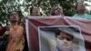 Bangladeshi social activists hold a banner displaying a portrait of blogger and author Ananta Bijoy Das during a protest against his killing, in Dhaka, Bangladesh, May 12, 2015.
