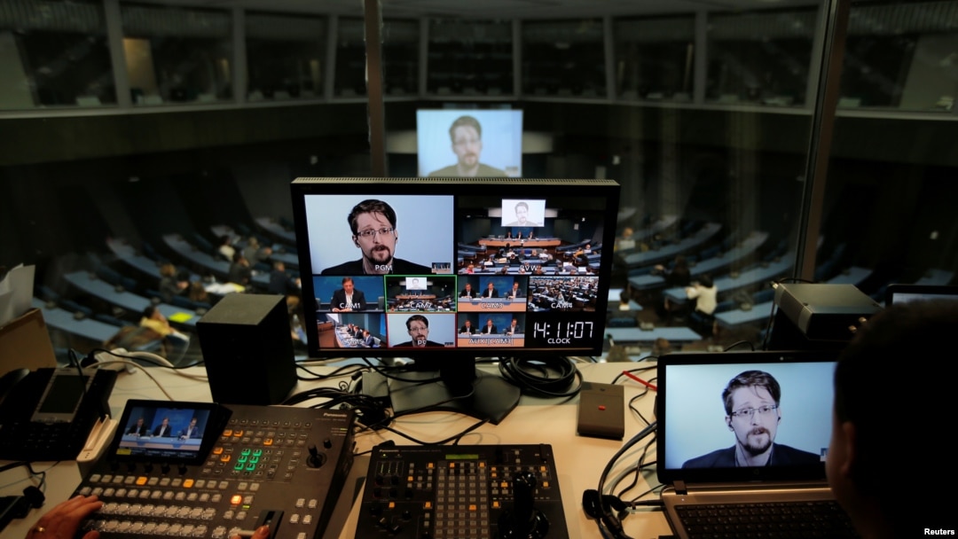 FILE - Edward Snowden speaks via video link as he takes part in a round table on the protection of whistleblowers at the Council of Europe in Strasbourg, France, March 15, 2019.