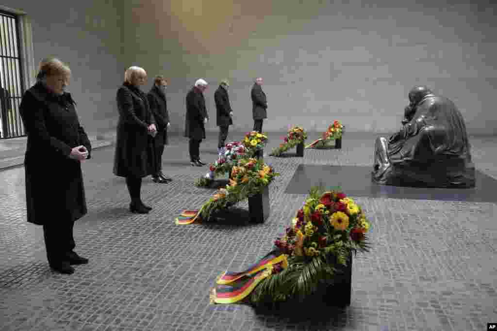 From right: German Chancellor Angela Merkel, Vice President of the German Parliament Bundestag Claudia Roth, France's President Emmanuel Macron, German President Frank-Walter Steinmeier, the President of Germany's upper house Bundesrat Daniel Guenther and the President of Germany's Federal Constitutional Court Andreas Vosskuhle attend a wreath laying ceremony at the Central Memorial for the Victims of War and Dictatorship in Berlin.