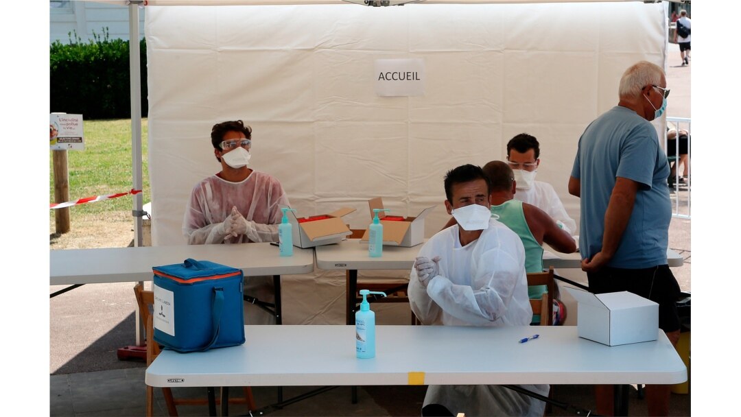 Health-care workers prepare to test people with COVID-19 symptoms near the beach in Saint Jean de Luz, southwestern France, Monday, July 27, 2020.
