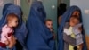 FILE - Women hold babies suffering from malnutrition as they wait at a UNICEF clinic in Jabal Saraj, north of Kabul, Afghanistan, Aug. 26, 2019. The UNICEF representative in the country says his agency and its female staff are continuing to work there despite Taliban restrictions