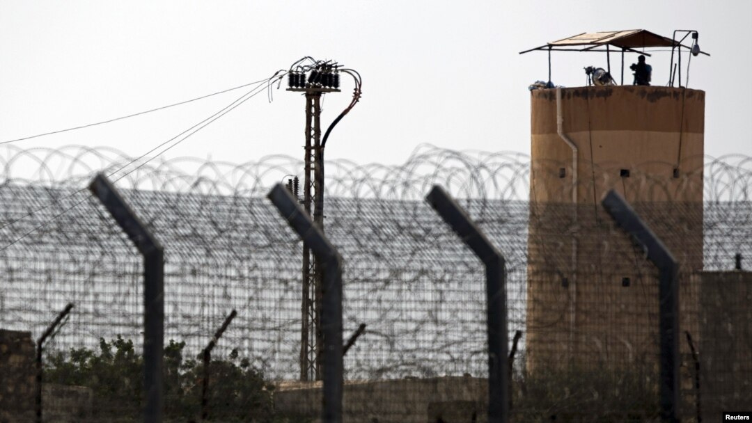 A member of Egypt's security forces stands on a watchtower in North Sinai as seen from across the border in southern Israel, July 1, 2015.