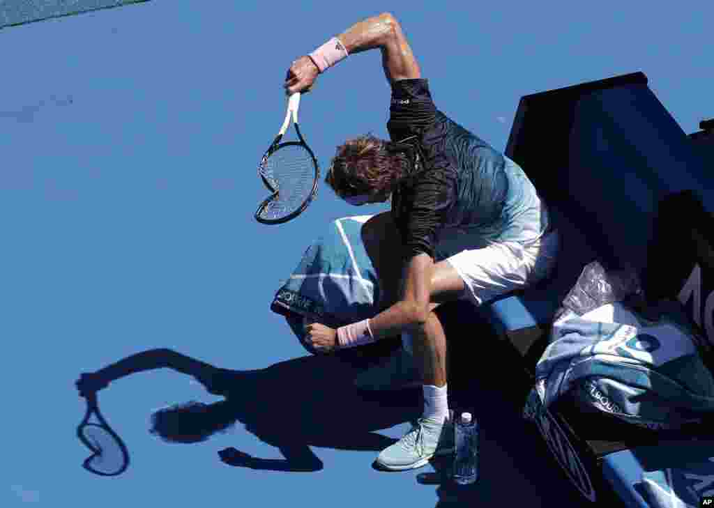 Germany's Alexander Zverev smashes his racket in frustration during his fourth round match against Canada's Milos Raonic at the Australian Open tennis championships in Melbourne, Australia.